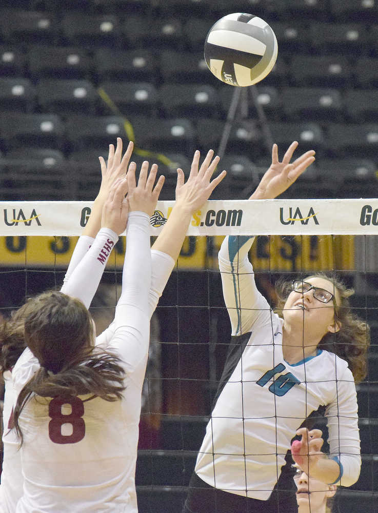 Photo by Joey Klecka/Peninsula Clarion Nikiski middle Ayla Pitt reaches for a ball against Mt. Edgecumbe's Daisy Hunt (8) Saturday in the Class 3A state volleyball championship at the Alaska Airlines Arena in Anchorage.