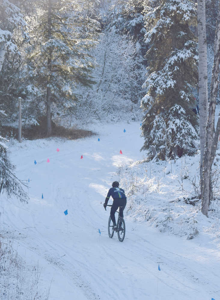 Photo by Joey Klecka/Peninsula Clarion A cyclist makes his way up a hill on the Tsalteshi Trails during the Polar Vortex race Oct. 22 in Soldotna.