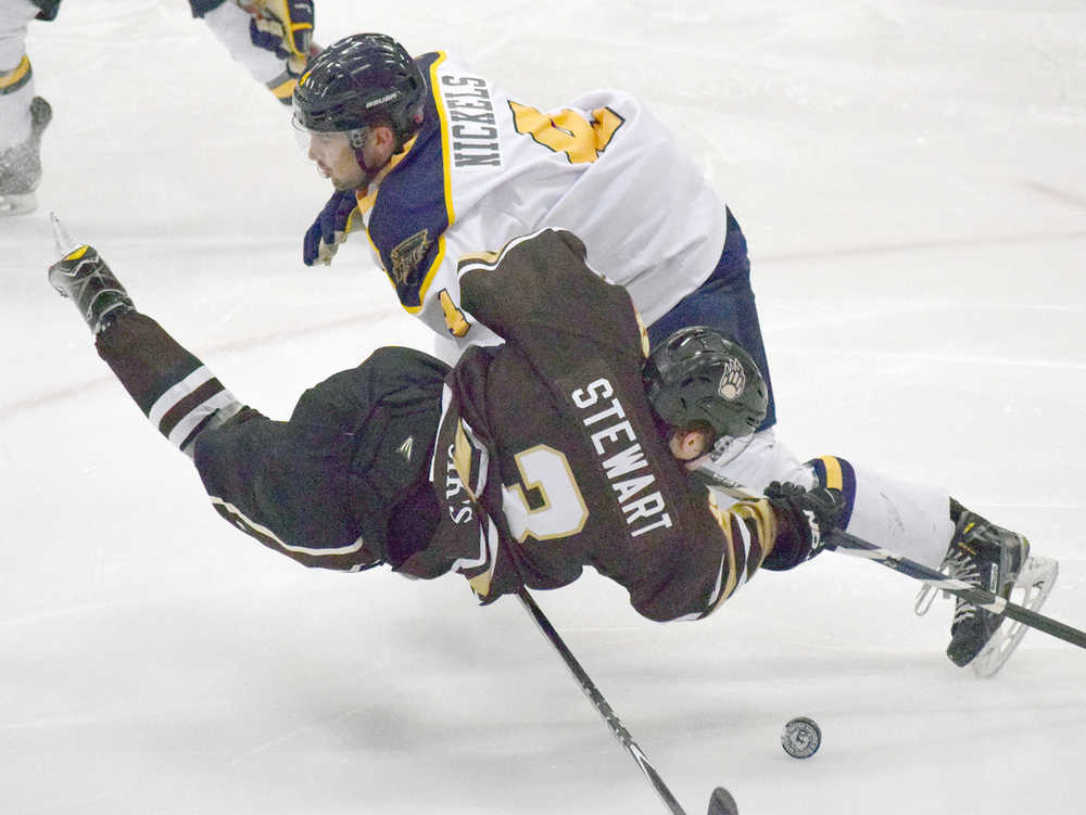 Photo by Joey Klecka/Peninsula Clarion Springfield Jr. Blues defenseman Jack Nickels battles for the puck with Kenai River Brown Bears forward Ethan Stewart Friday night at the Soldotna Regional Sports Complex.