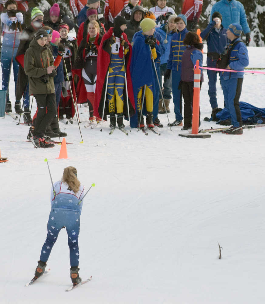 Photo by Joey Klecka/Peninsula Clarion A Soldotna skier races by a group of people cheering Jan. 22, 2016, at the Tsalteshi Trails.