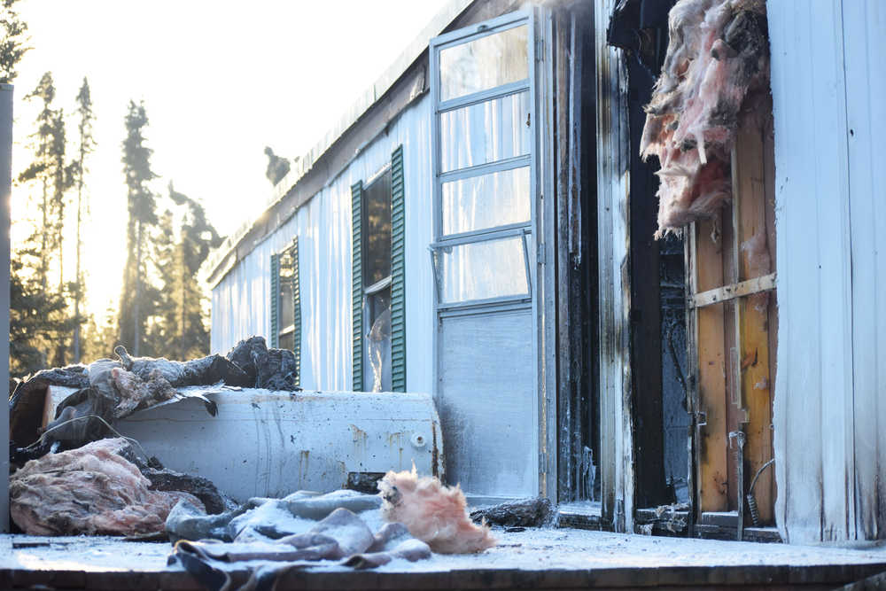 Photo by Megan Pacer/Peninsula Clarion Debris litters the back porch of a mobile home that caught fire Tuesday, Nov. 22, 2016 on Blanch Street, off of Kalifornsky Beach Road, near Soldotna, Alaska. The back bedroom and bathroom area of the mobile home caught fire Tuesday afternoon, though firefighters were able to put it out within minutes and none of the occupants were hurt.