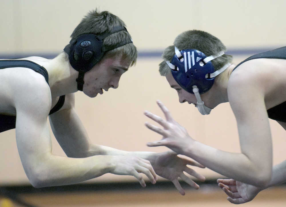 Photo by Jeff Helminiak/Peninsula Clarion Soldotna's Brayde Wolfe and Nikiski's Malcolm Yerkes prepare to engage at 126 pounds Wednesday at Soldotna Prep. Wolfe was able to pin Yerkes.