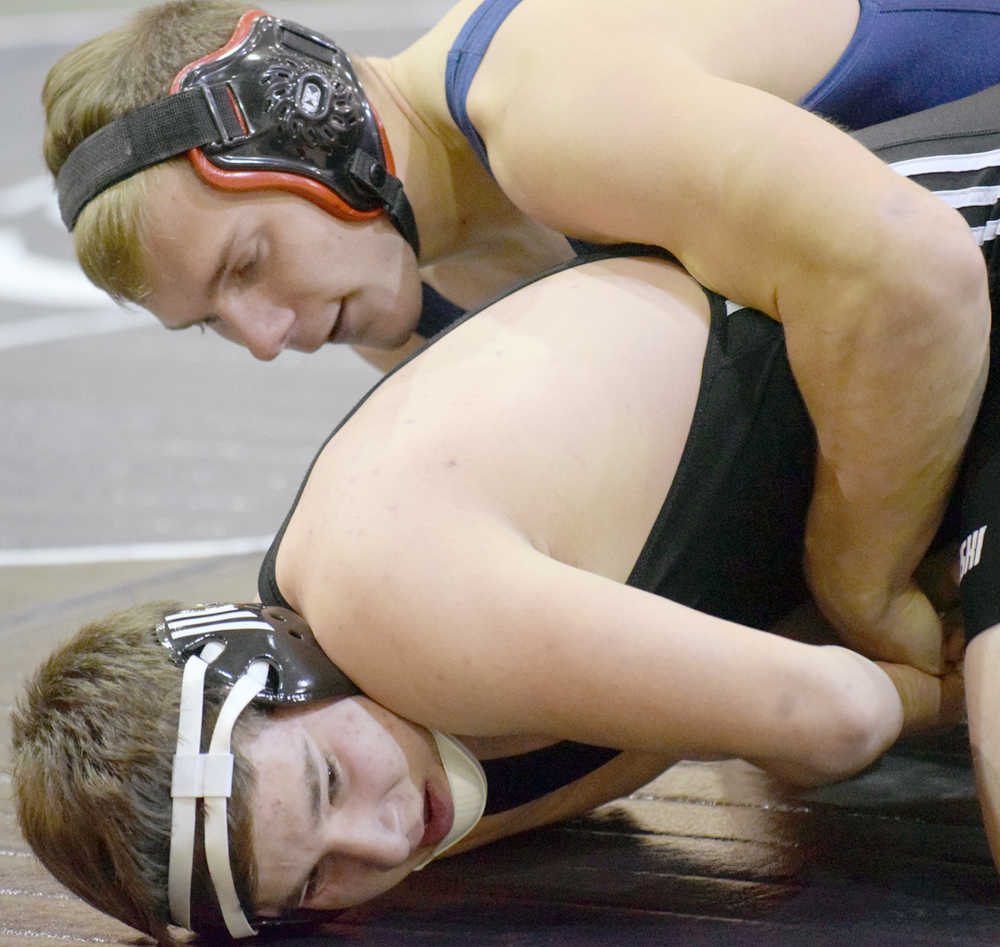 Photo by Jeff Helminiak/Peninsula Clarion Soldotna's Austin Schrader controls Nikiski's Dustin Mullins at 182 pounds Wednesday at Soldotna Prep. Schrader would earn a pin in the third period.