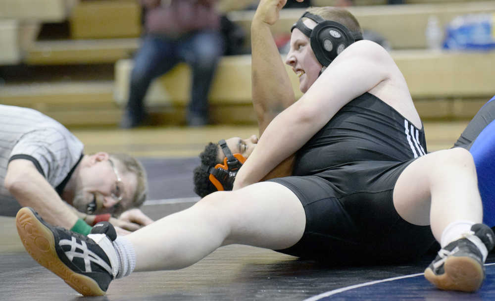 Photo by Jeff Helminiak/Peninsula Clarion Nikiski's Ethan Hack prepares to pin Soldotna's Eli Floyd in an exhibtion match at 220 pounds Wednesday at Soldotna Prep.