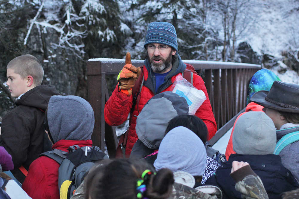 Seward Elementary teacher Jason Leslie counts students before crossing a creek to Manitoba cabin during a field trip on Tuesday, Nov. 11 near the Seward Highway.