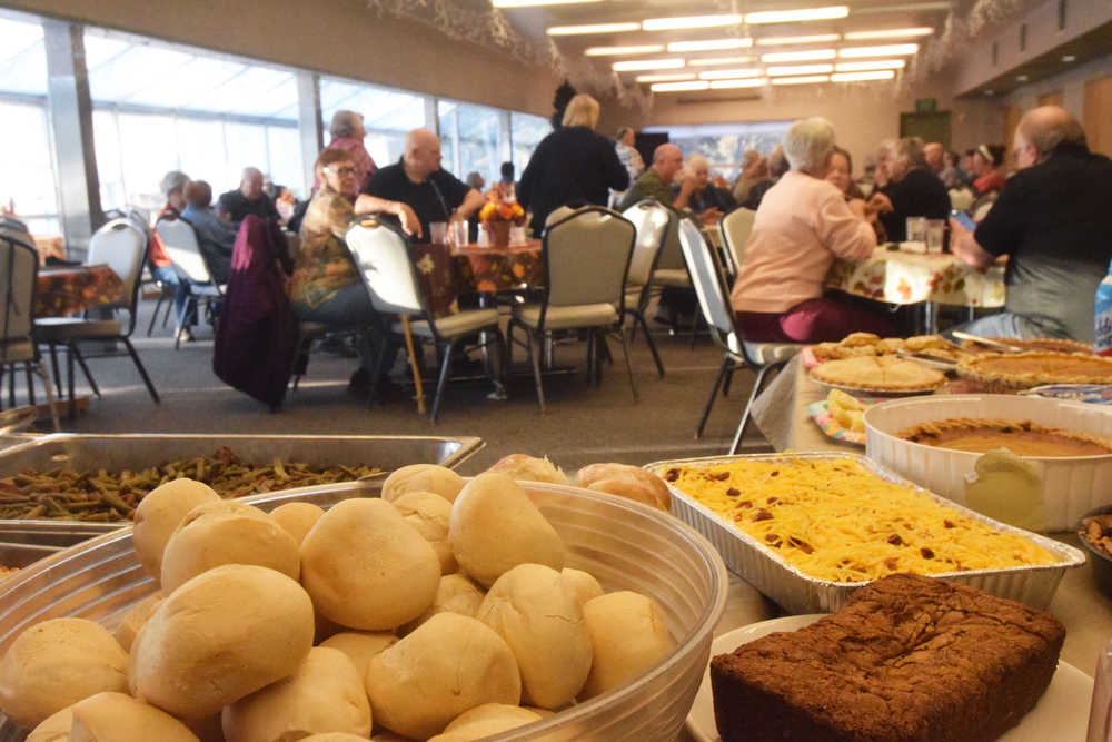 Photo by Megan Pacer/Peninsula Clarion Hungry area residents prepare to devour a Thanksgiving meal put on by volunteers Thursday, Nov. 24, 2016 at the Kenai Senior Citizens Center in Kenai, Alaska. Volunteers said they expected to feed 40-45 people during this year's potluck.