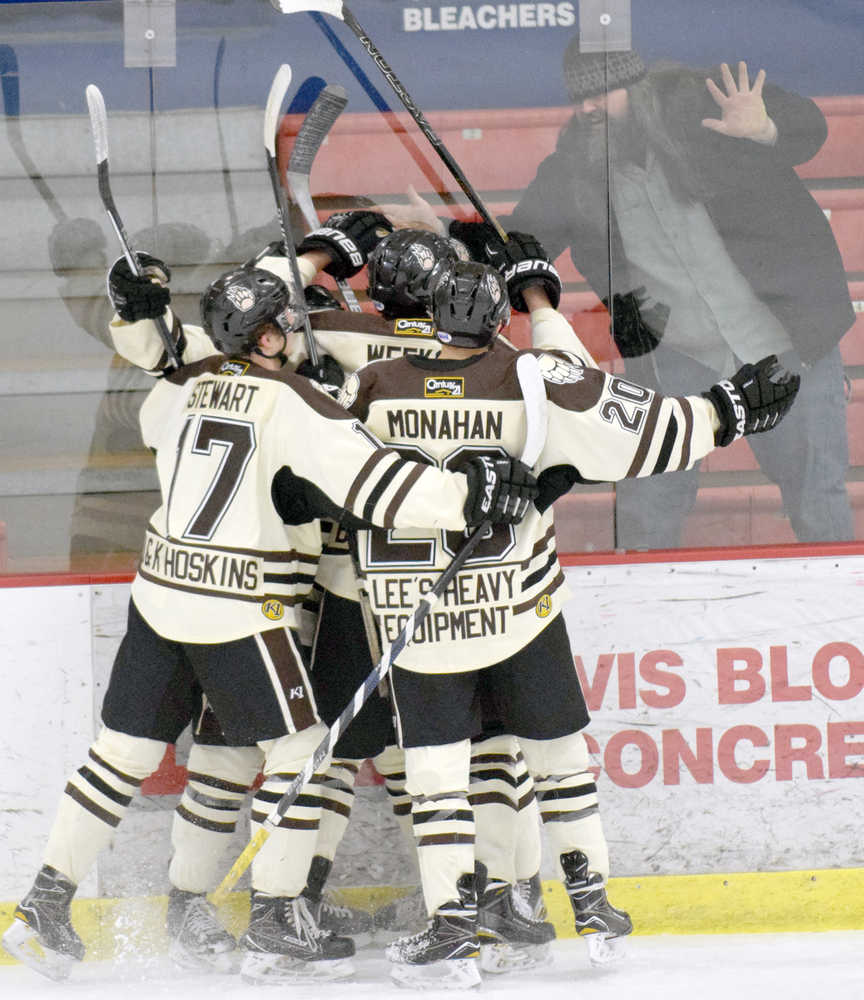 Photo by Jeff Helminiak/Peninsula Clarion The Kenai River Brown Bears celebrate a first-period goal by Anthony Tzveyn on Friday at the Soldotna Regional Sports Complex.