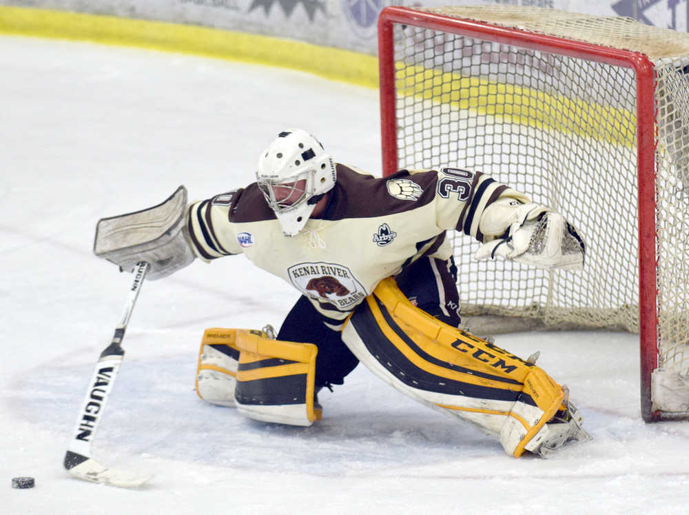 Photo by Jeff Helminiak/Peninsula Clarion Brown Bears goalie Robbie Goor pokes away an attack Friday at the Soldotna Regional Sports Complex.