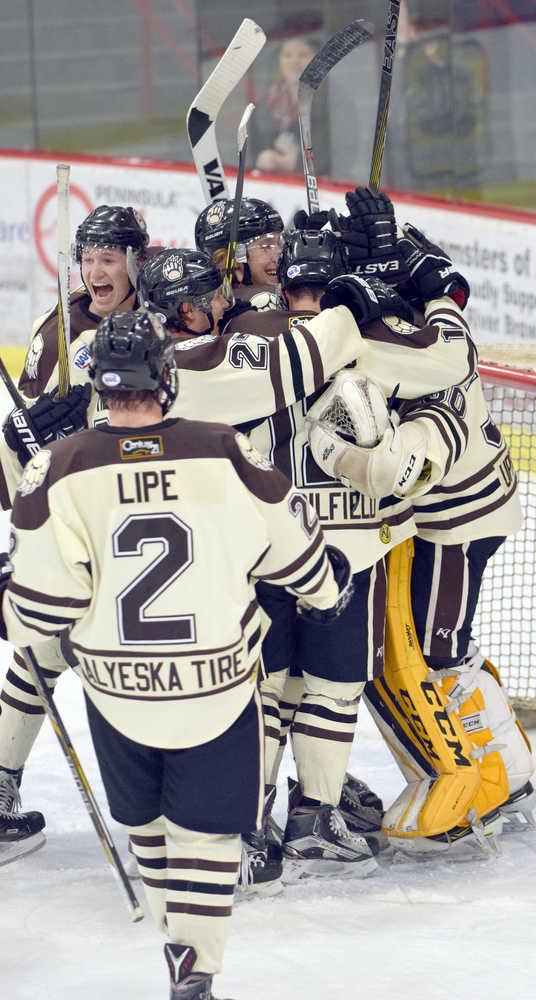 Photo by Jeff Helminiak/Peninsula Clarion The Brown Bears mob goalie Robbie Goor after a 5-2 victory over the Fairbanks Ice Dogs on Friday at the Soldotna Regional Sports Complex.