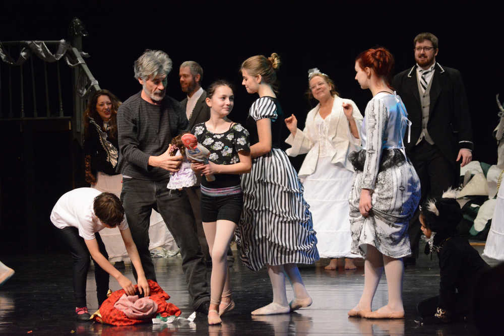 Brian Duffy, center, as Uncle Drosselmeyer, distributes gifts to children in the party scene during rehearsals last Friday at the Homer Mariner Theatre.