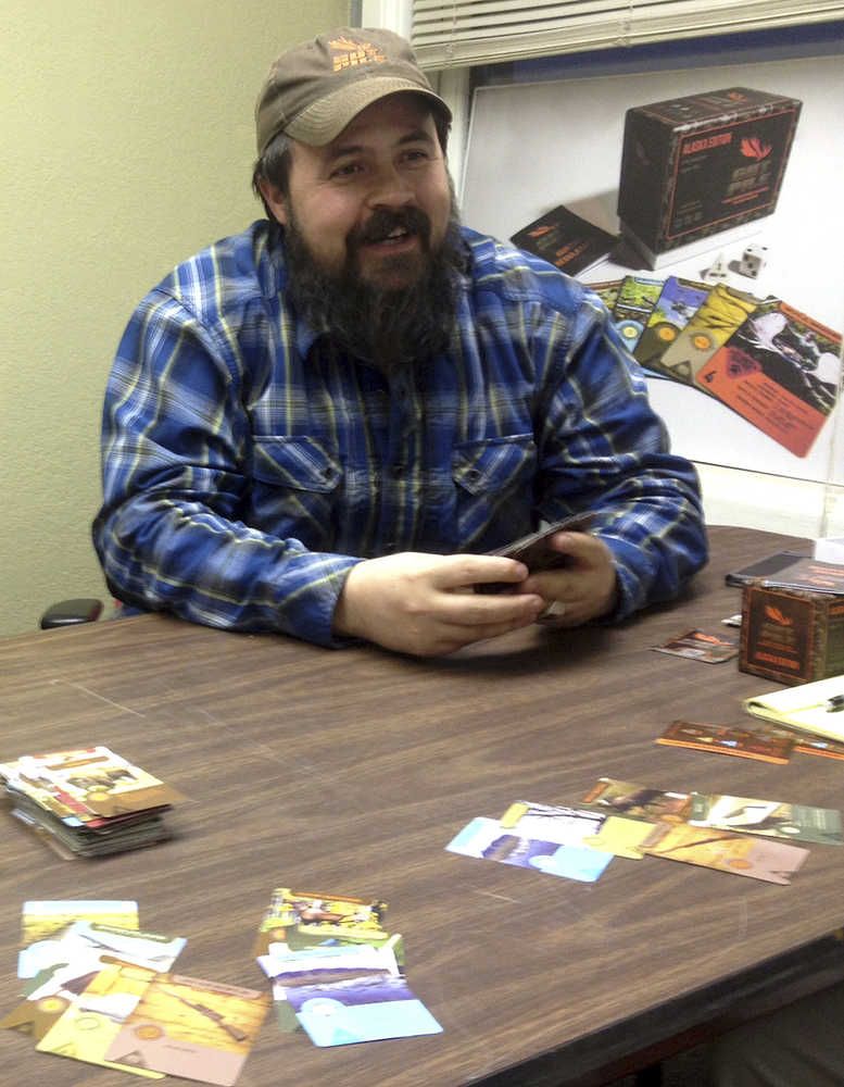 In this Oct. 24, 2016 photo, Jim Clark plays a game of Gut Pile in Fairbanks, Alaska. The card game is a Fairbanks-designed product where players score points by assembling the elements for a perfect hunt while avoiding their opponent's attack cards like; hypothermia, beaver fever and the always-dangerous People for the Ethical Treatment of Animals card.  (Sam Friedman/The News-Miner via AP)