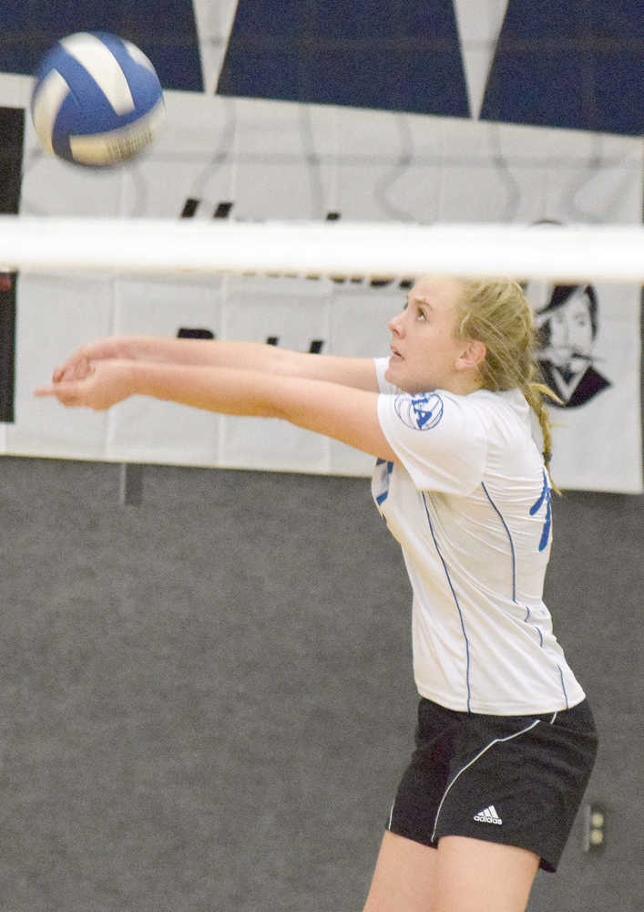 Photo by Joey Klecka/Peninsula Clarion Cook Inlet Academy's Sarah Hollers sets the ball up for a teammate Friday at the Borealis Conference volleyball tournament at CIA.