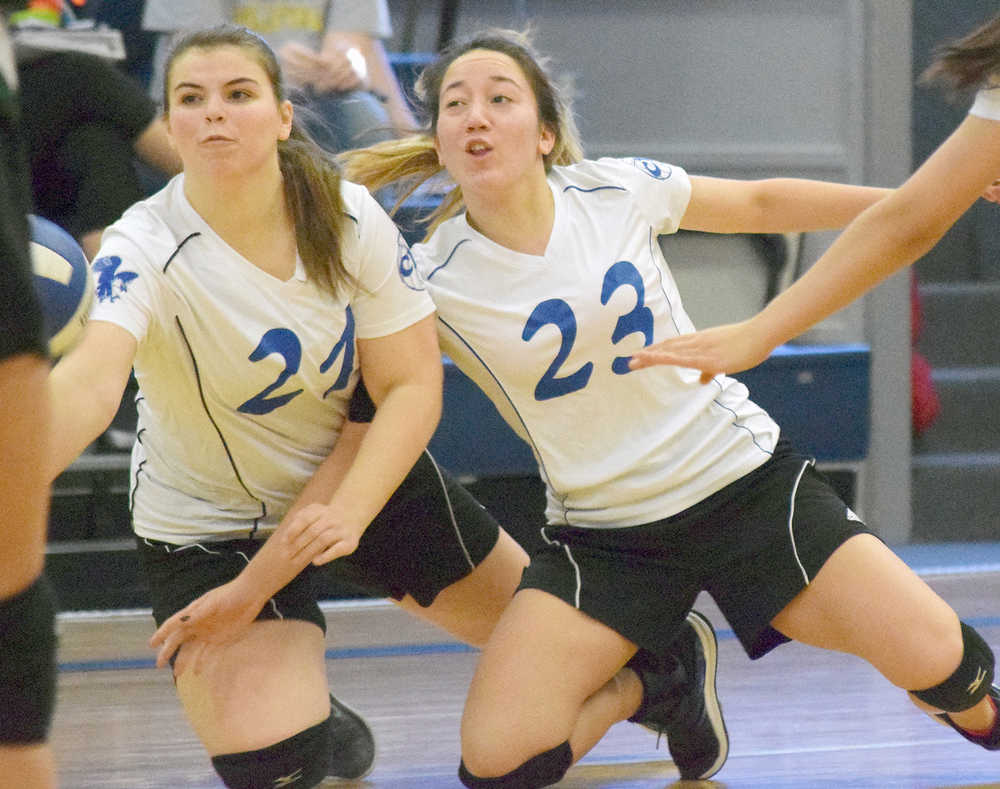 Photo by Joey Klecka/Peninsula Clarion Anna Cizek (left) and Cook Inlet Academy teammate Breona Delon both dive for a ball Friday at the Borealis Conference volleyball tournament held at CIA.