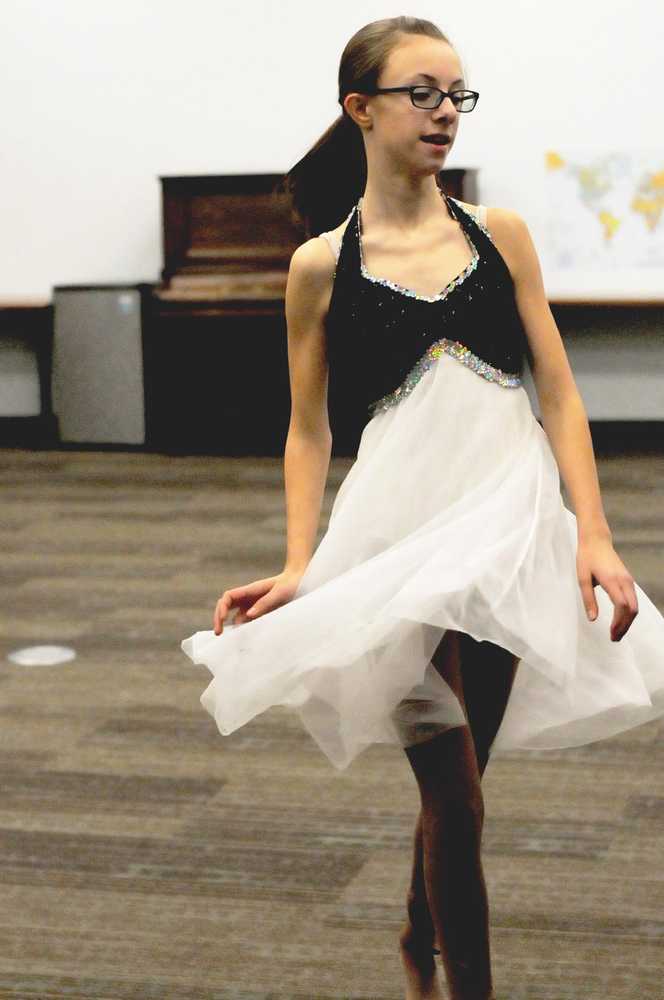 Photo by Elizabeth Earl/Peninsula Clarion Kaidence Shaeffer, one of the skaters who will perform in the annual "Christmas Lights and Holiday Nights" skating recital, runs through one of her routines at the Soldotna Public Library on Monday, Dec. 5, 2016 in Soldotna, Alaska. The recital, scheduled for Dec. 17 at 1:15 p.m. at the Soldotna Regional Sports Complex, will feature a number of holiday ice skating performances, followed by a free public skate from 5-7 p.m. The organizers will also be accepting donations of holiday dinner items. The donations will go to families in need of a holiday dinner.