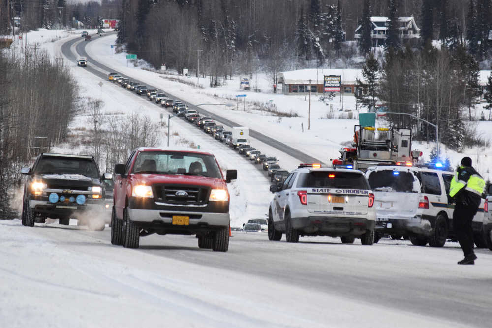 Photo by Megan Pacer/Peninsula Clarion Soldotna Police officers block off part of the Sterling Highway following a two-vehicle collision Thursday, Dec. 8, 2016 near the intersection of the highway and Mackey Lake Road in Soldotna, Alaska. One person was killed in the crash and the other taken to Central Peninsula Hospital to be treated for injuries.