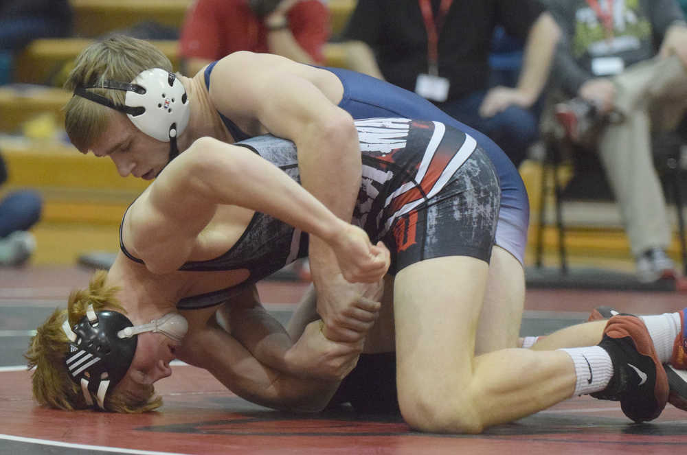 Photo by Joey Klecka/Peninsula Clarion Bechler Metcalf of Soldotna wrestles with Wasilla's Andrue Shepersky in the 152-pound championship bout at the Northern Lights Conference tournament Saturday at Kenai Central High School.