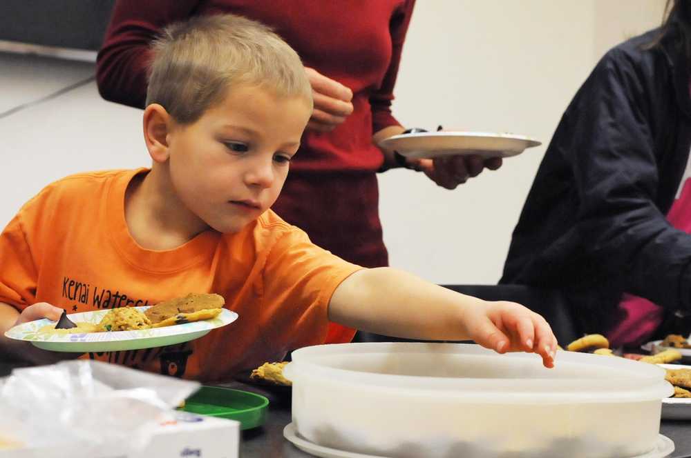 Quinton Beplat, 6, picks out cookies during a cookie exchange at the Kenai Community Library on Sunday, Dec. 11, 2016 in Kenai, Alaska. The library hosted a one-for-one cookie exchange on Sunday, attracting about six attendees.