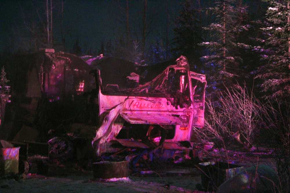 Photo by Megan Pacer/Peninsula Clarion The lights of emergency vehicles illuminate a burned mobile home on Industrial Road off Funny River Road on Dec. 11, 2016 in Soldotna, Alaska. Central Emergency Services extinguished the fire with no damage to the neighboring mobile home.