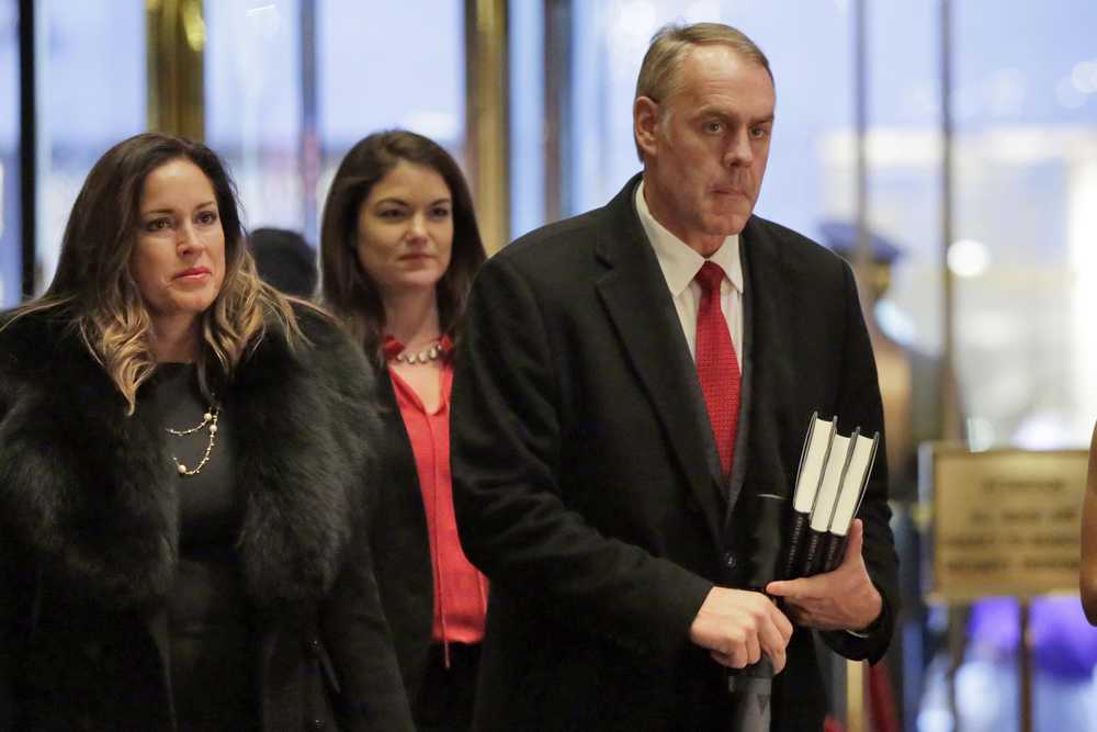 Rep. Ryan Zinke, right, R-Mont., arrives in Trump Tower, in New York, Monday, Dec. 12, 2016. (AP Photo/Richard Drew)