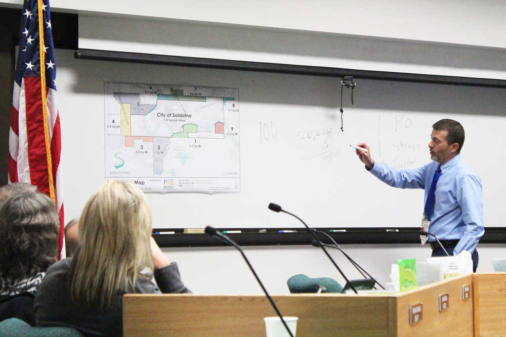 Photo by Megan Pacer/Peninsula Clarion Soldotna City Manager Mark Dixson explains the city's process and purpose for exploring possible annexation of areas surrounding the city during a Soldotna City Council meeting Wednesday, Dec. 14, 2016 at Soldotna City Hall in Soldotna, Alaska. The council voted to appropriate $50,000 to fund a public engagement process with a consultant to find out what area residents think about the potential annexation of nine identified outlying areas.