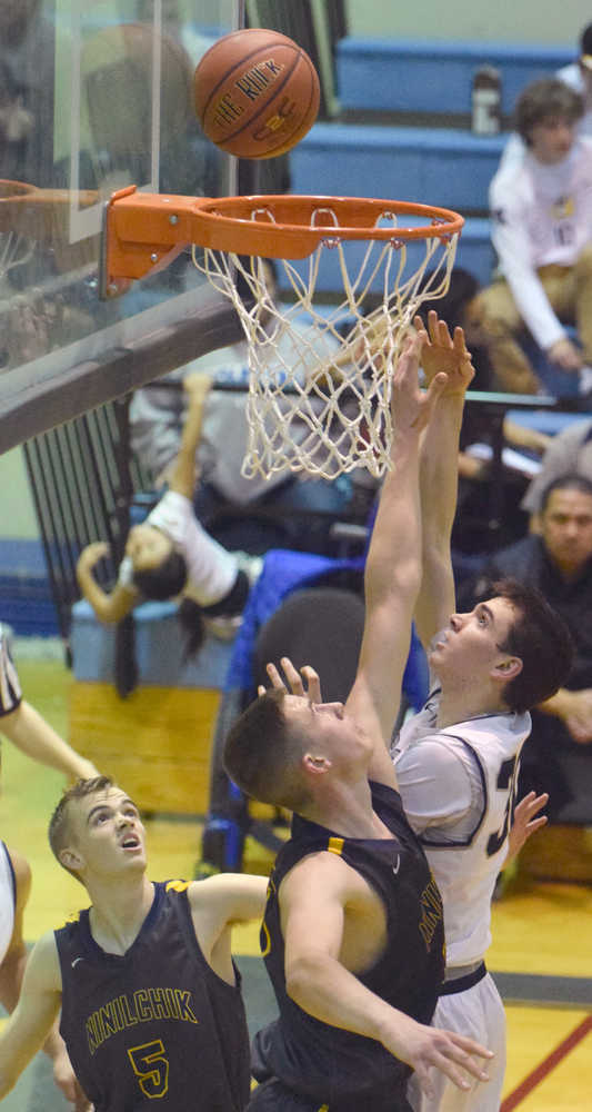 Photo by Jeff Helminiak/Peninsula Clarion Soldotna's Sam McElroy goes up for a shot against Ninilchik's Austin White on Friday at Soldotna High School.