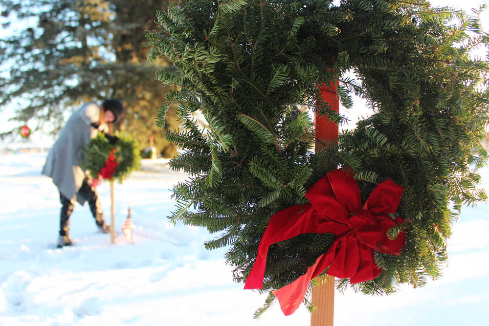 Photo by Megan Pacer/Peninsula Clarion From left to right: Joe Coup, Greg Fite and Ray Nickelson fire shots just before taps is played at a wreath-laying ceremony Saturday, Dec. 17, 2016 at the Kenai Municipal Cemetery in Kenai, Alaska. Bob Myles, a member of the VFW and American Legion, coordinated the peninsula's first wreath ceremony through the Wreaths Across America program. Community members hung wreaths on the graves of veterans in the Kenai and Soldotna cemeteries, and Myles is working to expand the event to more peninsula cemeteries next year.