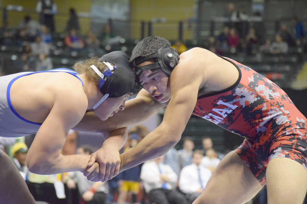 Photo by Joey Klecka/Peninsula Clarion Kenai Central senior Keyshawn McEnerny battles with Levi Farris of Palmer in the Class 4A state wrestling championship 152-pound bout, Saturday night at the Alaska Airlines Center in Anchorage.