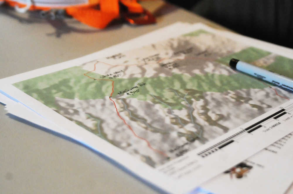 Photo by Elizabeth Earl/Peninsula Clarion A map that outlines the route that Chris Walden and his daughter Avery, 9, will take to summit Mt. Kilimanjaro sits on a table in the Waldens' home on Sunday, Dec. 18, 2016 near Soldotna, Alaska. Avery and Chris Walden, along with a family friend, will embark on an eight-day expedition to summit Mt. Kilimanjaro starting Dec. 31. If they succeed, Avery Walden will be the youngest female ever to summit the 19,341-foot mountain.