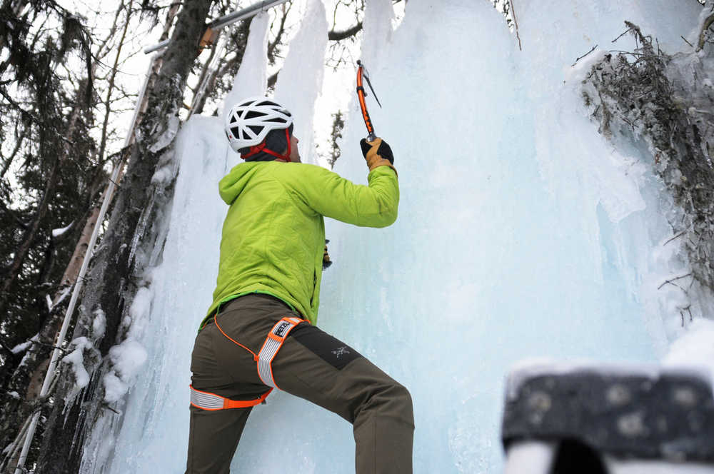 Photo by Elizabeth Earl/Peninsula Clarion Chris Walden demonstrates an ice climbing technique on the ice wall he set up in the back yard of his family's home on Sunday, Dec. 18, 2016 near Soldotna, Alaska. To build the ice wall, he set up a drip system with a PVC pipe between two trees with hanging pieces of twine to allow the ice to build up, and with the deep-freeze temperatures that hit the Kenai in early December, he soon had an ice wall multiple feet thick. Walden and his daughter Avery, 9, along with a family friend, will embark on an eight-day expedition to summit Mt. Kilimanjaro in Tanzania. If they succeed, Avery Walden will be the youngest female ever to summit the 19,341-foot mountain.