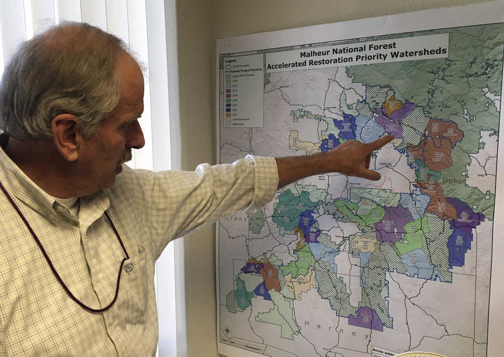 In this Dec. 7, 2016 photo, U.S. Forest Service District Ranger Dave Halemeier describes plans for part of the Malheur National Forest in John Day, Ore. The armed takeover of the Malheur National Wildlife Refuge headquarters caused a sensation and global headlines, but a quieter and perhaps more important struggle is being waged by those trying to use the levers of power, and not firearms.(AP Photo/Andrew Selsky)