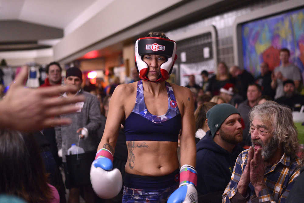 Photo by Ben Boettger/Peninsula Clarion Boxer Megan Anderson makes her way to the ring to face Robyn Sullens in the Fight Before Christmas martial arts event on Thursday, Dec. 22, 2016 at Soldotna's Peninsula Center Mall.