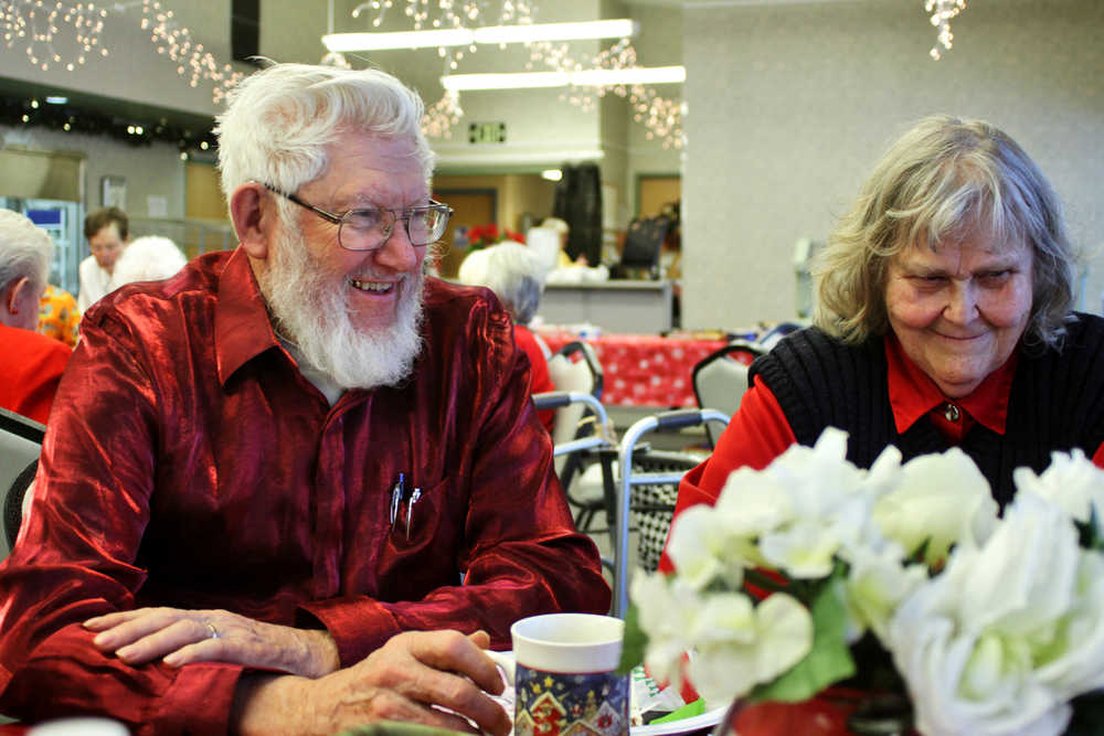 Photo by Ben Boettger/Peninsula Clarion Ray (left) and Marianne Nickleson laugh with friends over a Christmas lunch of ham, turkey, mashed potatoes, and pie at the Kenai Senior Center on Sunday, Dec. 25 in Kenai.