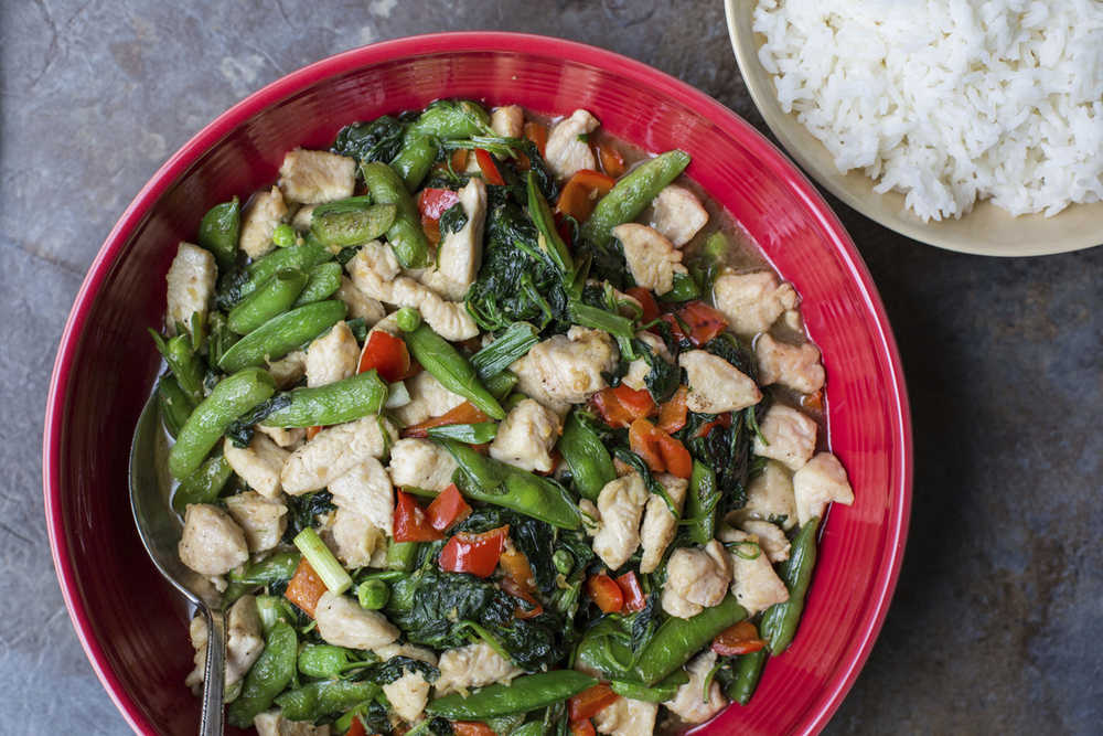 This November 2016 photo shows chicken and vegetable stir fry in New York. This dish is from a recipe by Katie Workman. (Sarah Crowder via AP)
