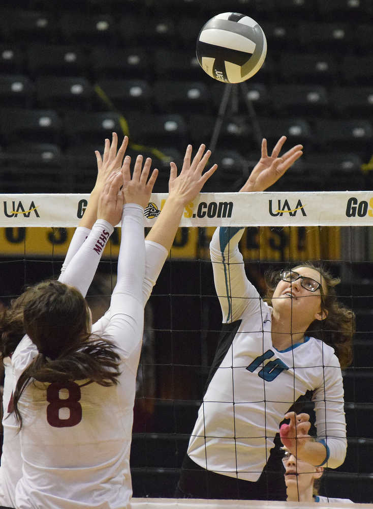 Photo by Joey Klecka/Peninsula Clarion Nikiski middle Ayla Pitt reaches for a ball against Mt. Edgecumbe's Daisy Hunt, Nov. 12 in the Class 3A state volleyball championship at the Alaska Airlines Arena in Anchorage.
