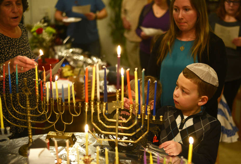 Ben Boettger Members of the Kenai peninsula's Briate Elohim Jewish congregation sing while lighting a collection of menorahs during a Hanukkah celebration at the home of member Allison Gottesman on Friday Dec. 30. This past Sunday was the last day of Hanukkah.