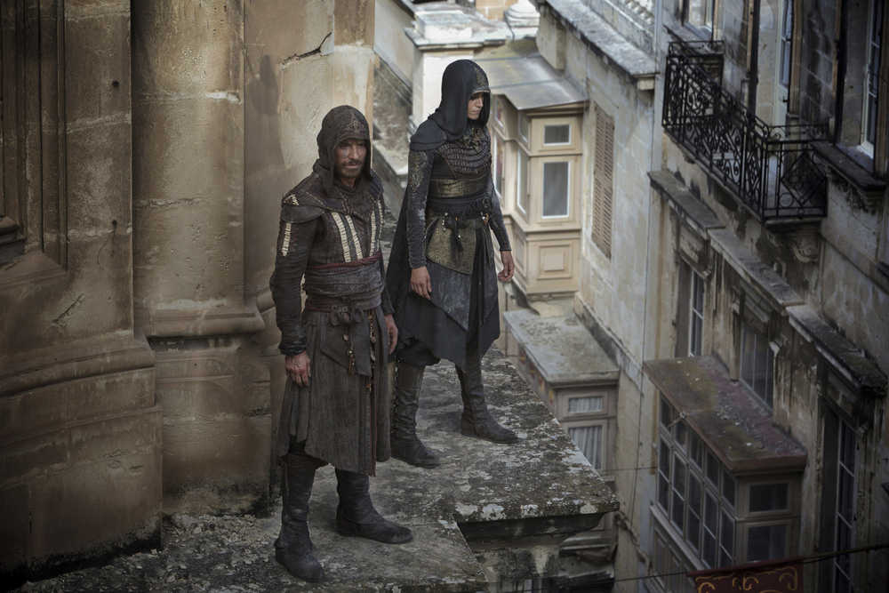 This image released by 20th Century Fox shows Michael Fassbender as Callum Lynch, left, and Ariane Labed as Maria in a scene from "Assassin's Creed."  (Kerry Brown/20th Century Fox via AP)