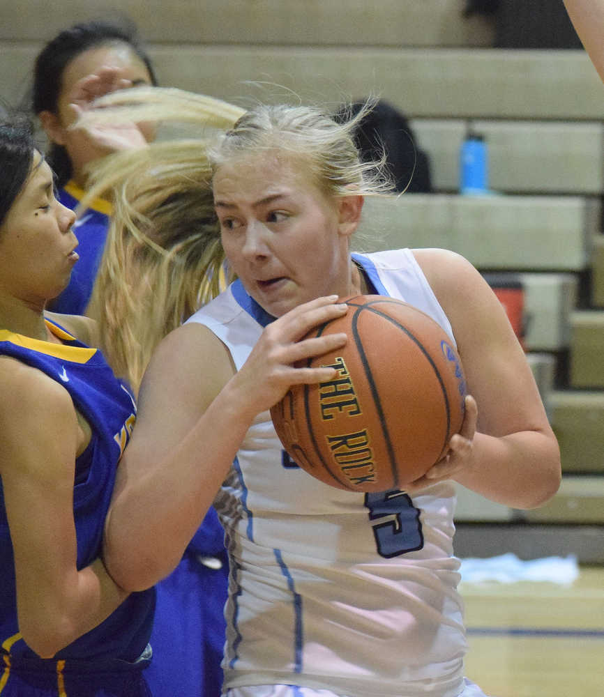 Photo by Joey Klecka/Peninsula Clarion Soldotna junior Melia Miller (front) works the paint against Kodiak in a Northern Lights Conference game Saturday at the Soldotna Prep gymnasium.