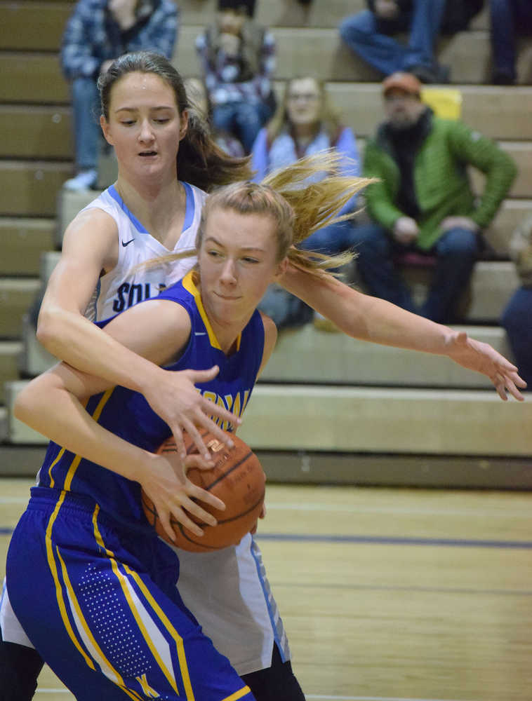 Photo by Joey Klecka/Peninsula Clarion Soldotna sophomore Brittani Blossom looks for an open teammate amidst a hoard of Kodiak defenders Saturday at the Soldotna Prep gymnasium.