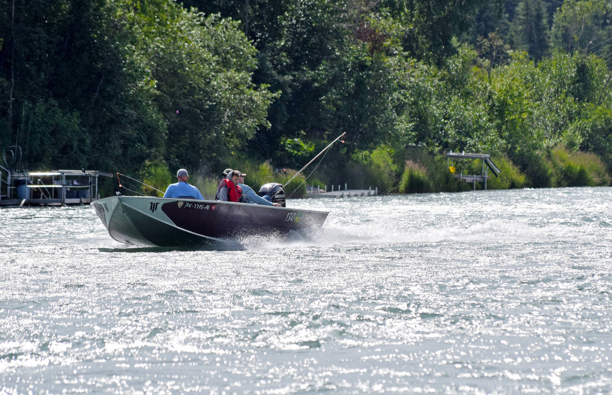 A guide motors a boat full of anglers up the Kenai River near Soldotna Creek Park on Wednesday, Aug. 1, 2018 in Soldotna, Alaska. (Photo by Elizabeth Earl/Peninsula Clarion)