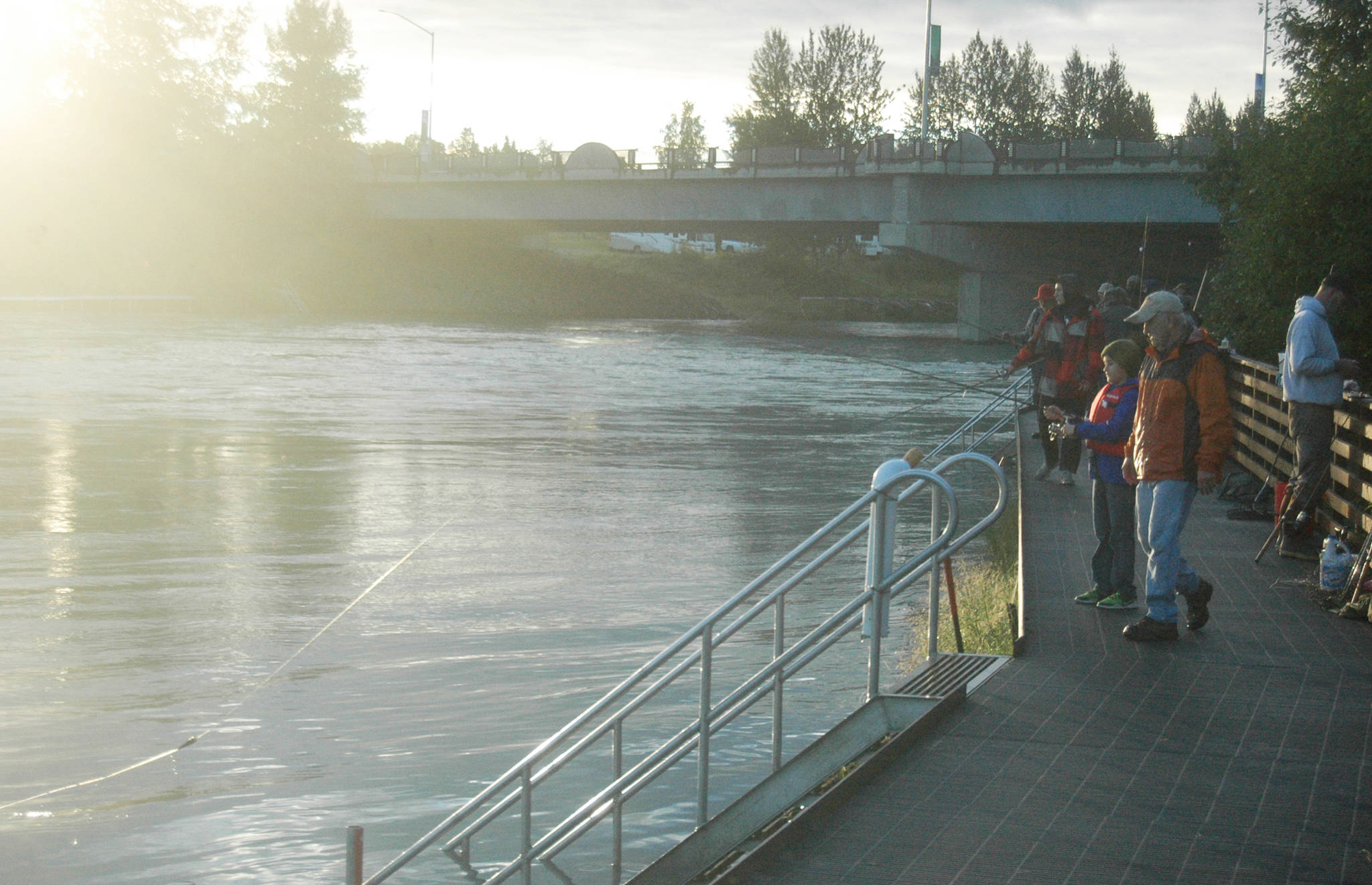 Fishermen cast for silver salmon from a boardwalk near the Soldotna Visitors Center on Wednesday, Aug. 8, 2018 in Soldotna, Alaska. (Photo by Elizabeth Earl/Peninsula Clarion)