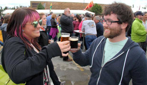 Mandy Leslie of Anchorage beers with her brother Zack Leslie of Kenai on Saturday, Aug. 9, 2018, at the Kenai Peninsula Beer Festival at the Soldotna Regional Sports Complex. Mandy Leslie said her favorite beer was the 12 quadruple beer from the 49th State Brewing Company, which won as the people’s choice for top beer. More than 15 breweries from all around the state participated in the festival, a fundraiser for the Rotary Club of Soldotna with benefits going to local Rotary projects. (Photo by Dan Balmer/Peninsula Clarion)