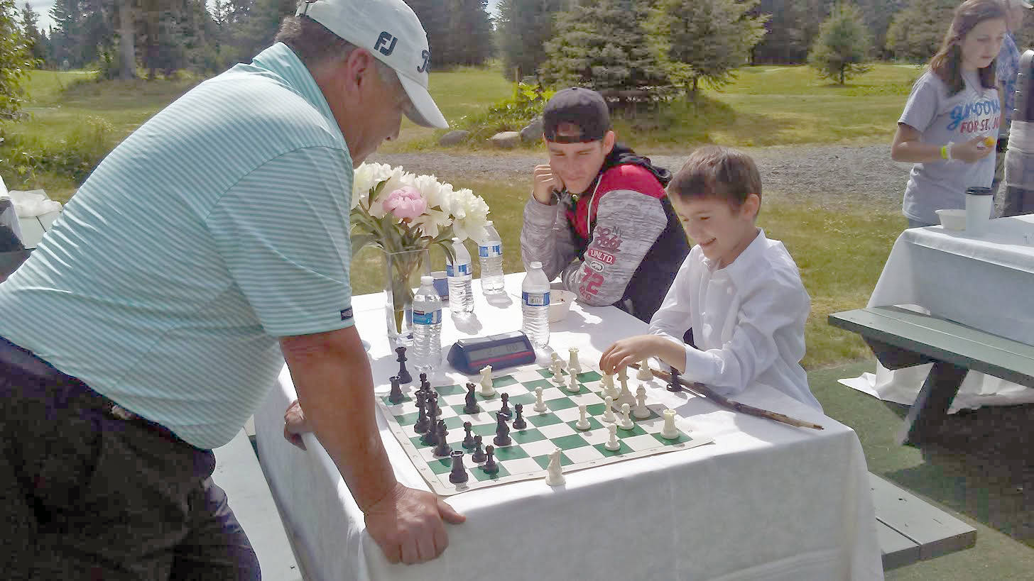 Attendees enjoy a game of chess at the Alaska Chess fundraiser on July 29 at Fireweed Meadows Golf Course in Anchor Point. (Photo courtesy of Colleen Evanco)