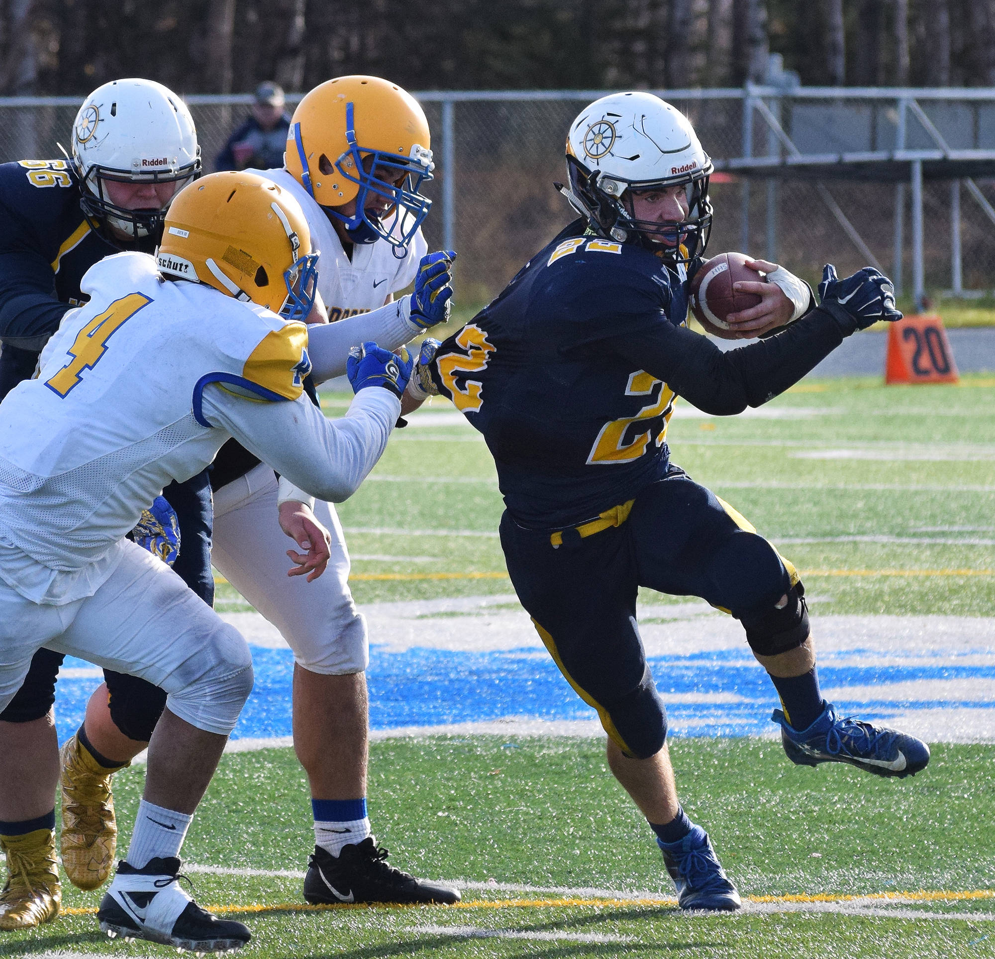 Homer sophomore Noah Fisk (right) tries to evade a pair of Utqiagvik tacklers Oct. 14, 2017, in the ASAA First National Bank Division III state championship at Machetanz Field in Palmer. (Photo by Joey Klecka/Peninsula Clarion)