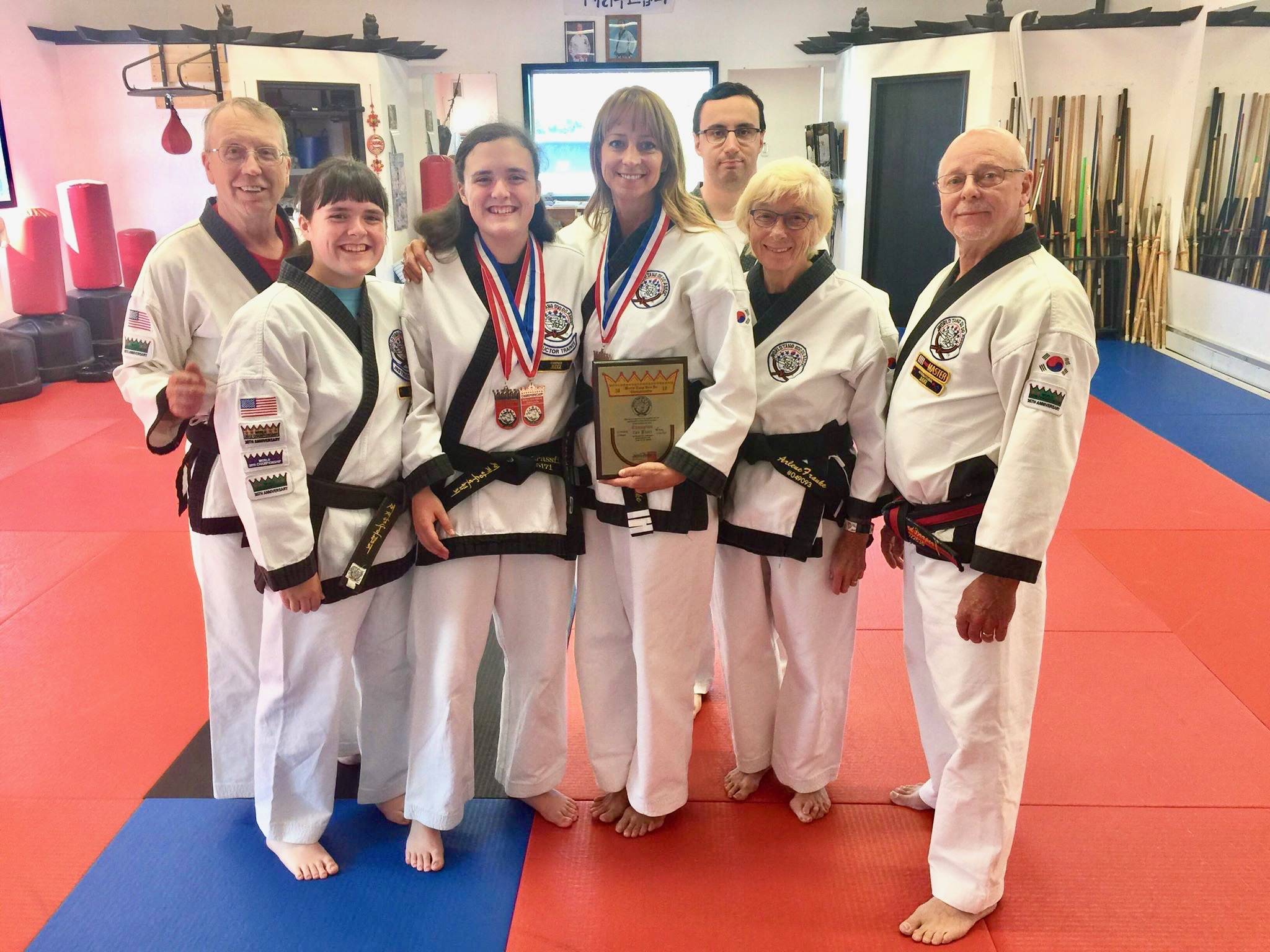 Cierra Brassfield, Edward Welch, Mika Brassfield, Shari Franke, Arlene Franke, Danny MacIntosh and Master Bud Draper pose with their medals and plaques after returning from the World Tang Soo Do Championships on Thursday, Aug. 9, 2018, near Soldotna, Alaska. (Photo by Victoria Petersen/Peninsula Clarion)