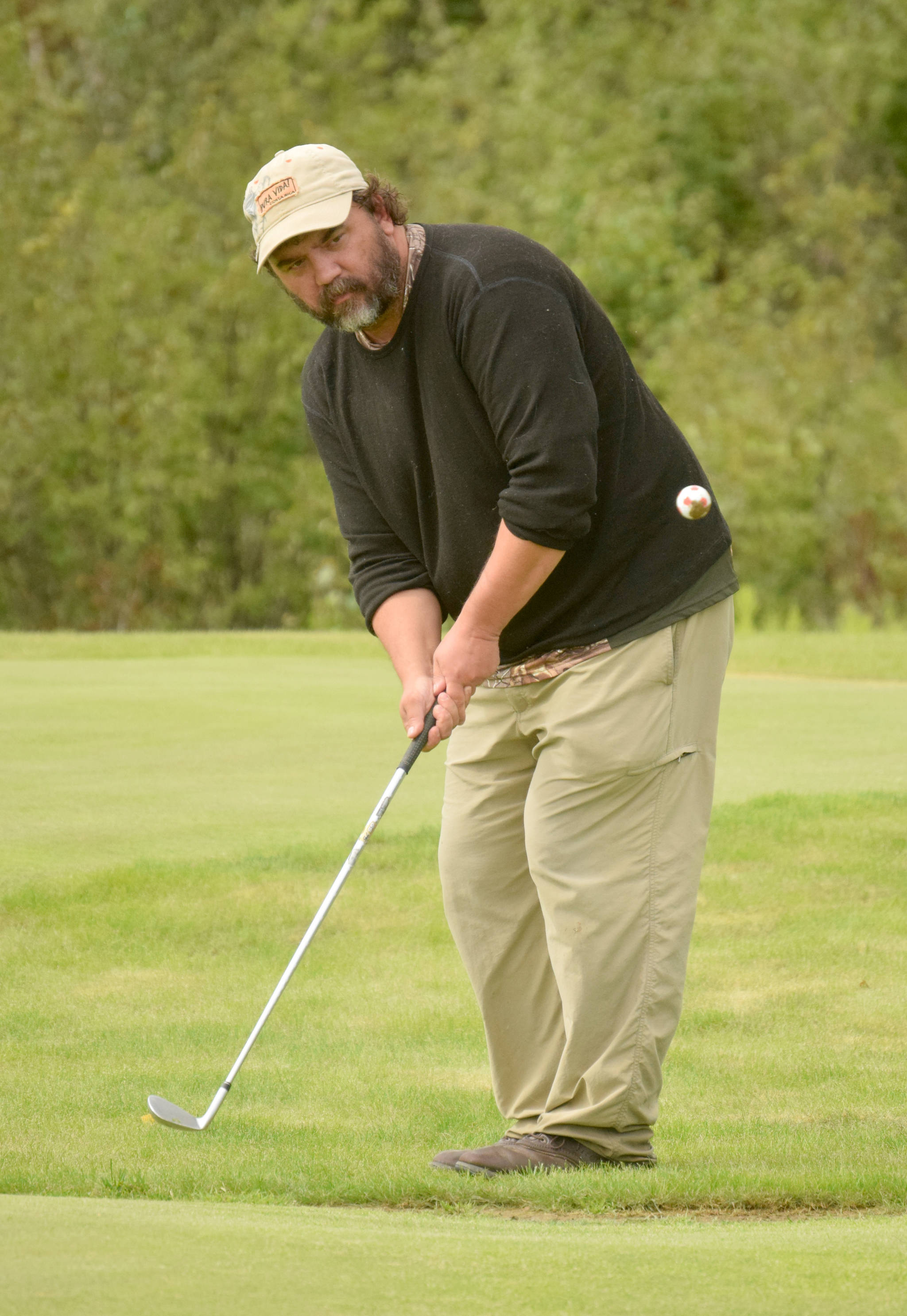 Todd Eskelin chips to the 18th green Sunday, Aug. 12, 2018, at the Donald R. Morgan Memorial Club Championship at Kenai Golf Course. (Photo by Jeff Helminiak)