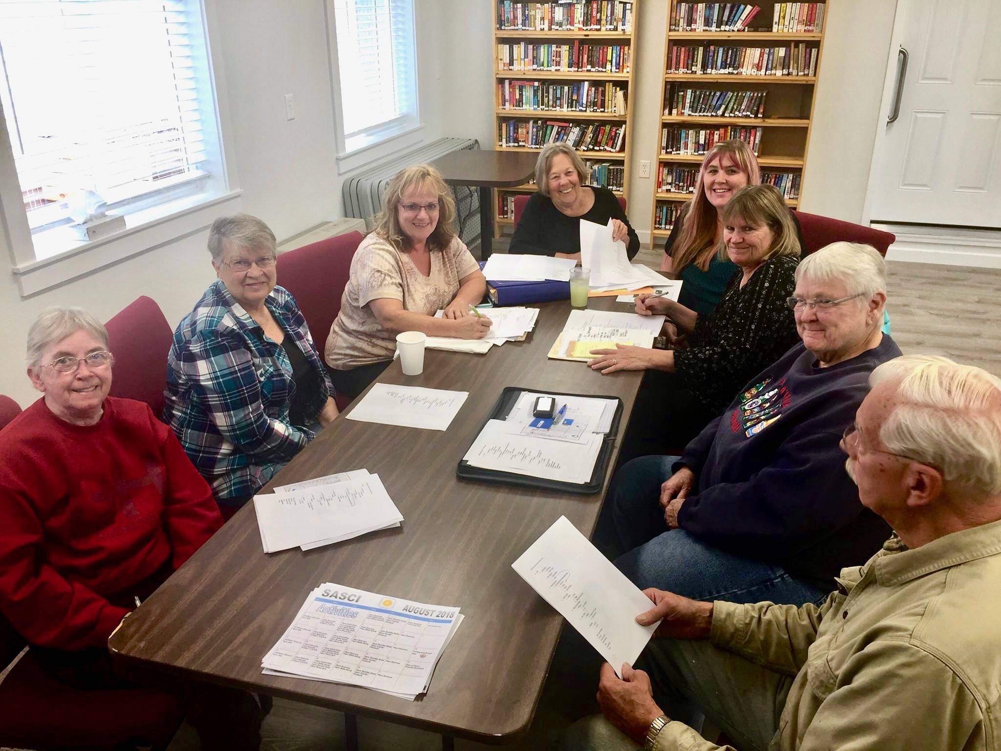 Sterling Area Senior Citizens Inc. board members and volunteers Linda Bond, Sandy Bailey, Janet Jones, Jacquie Turpin, Kristie Bass, Lynn Near, Dee Duvall and Dale Lundell met to discuss plans for the Sterling Street Fair at the Sterling Senior Center in Sterling, Alaska, on Monday, Aug. 13, 2018. (Photo by Victoria Petersen/Peninsula Clarion)