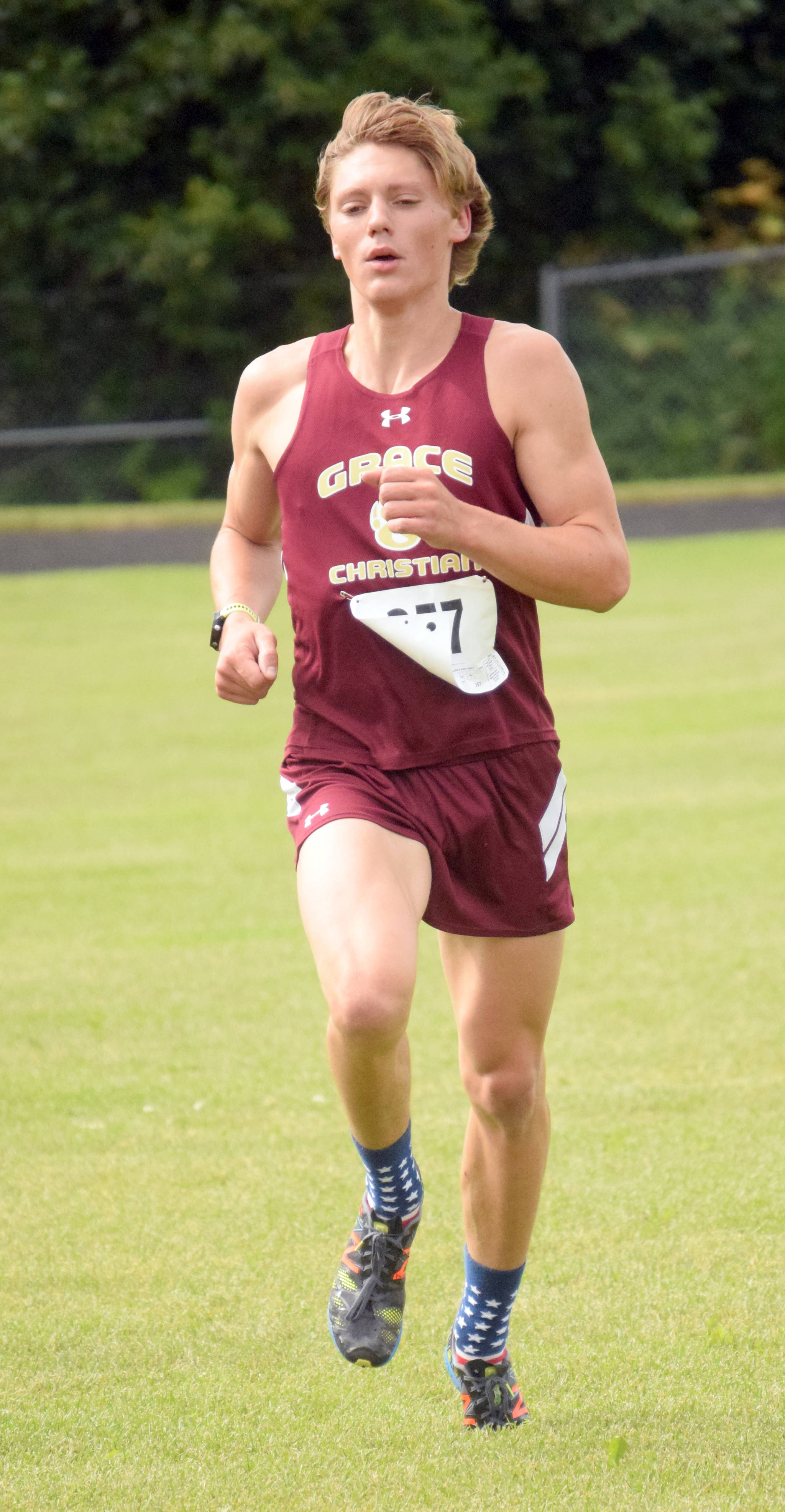 Grace Christian senior Gabe Martin finishes off a victory in the junior-senior boys race at the Nikiski Class Races on Monday, Aug. 13, 2018, at Nikiski High School. (Photo by Jeff Helminiak/Peninsula Clarion)