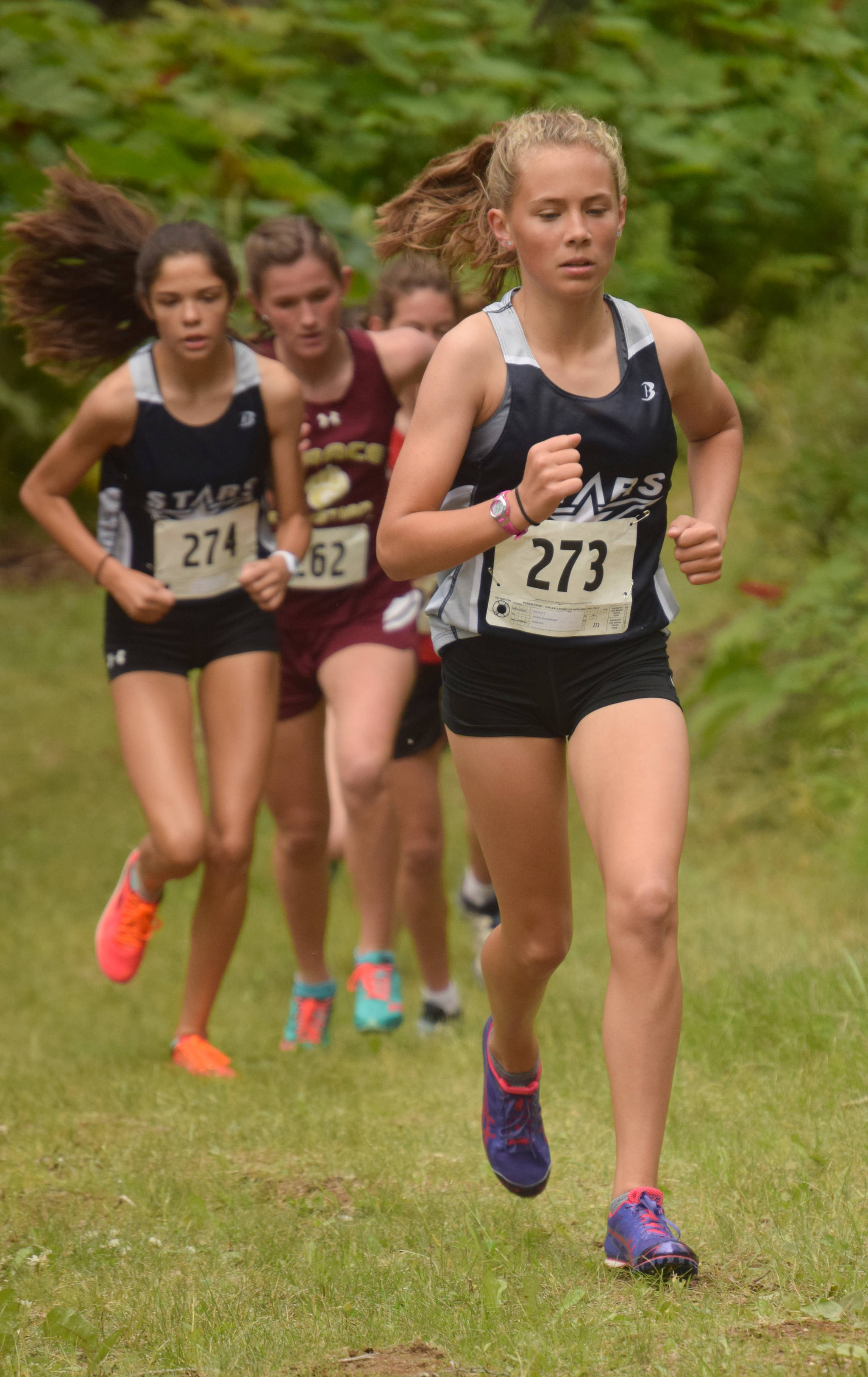 Soldotna freshman Jordan Strausbaugh leads a pack up a hill early in the freshman/sophomore girls race Monday, Aug. 13, 2018, at the Nikiski Class Races at Nikiski High School. Strausbaugh would go on to win the race. (Photo by Jeff Helminiak/Peninsula Clarion)