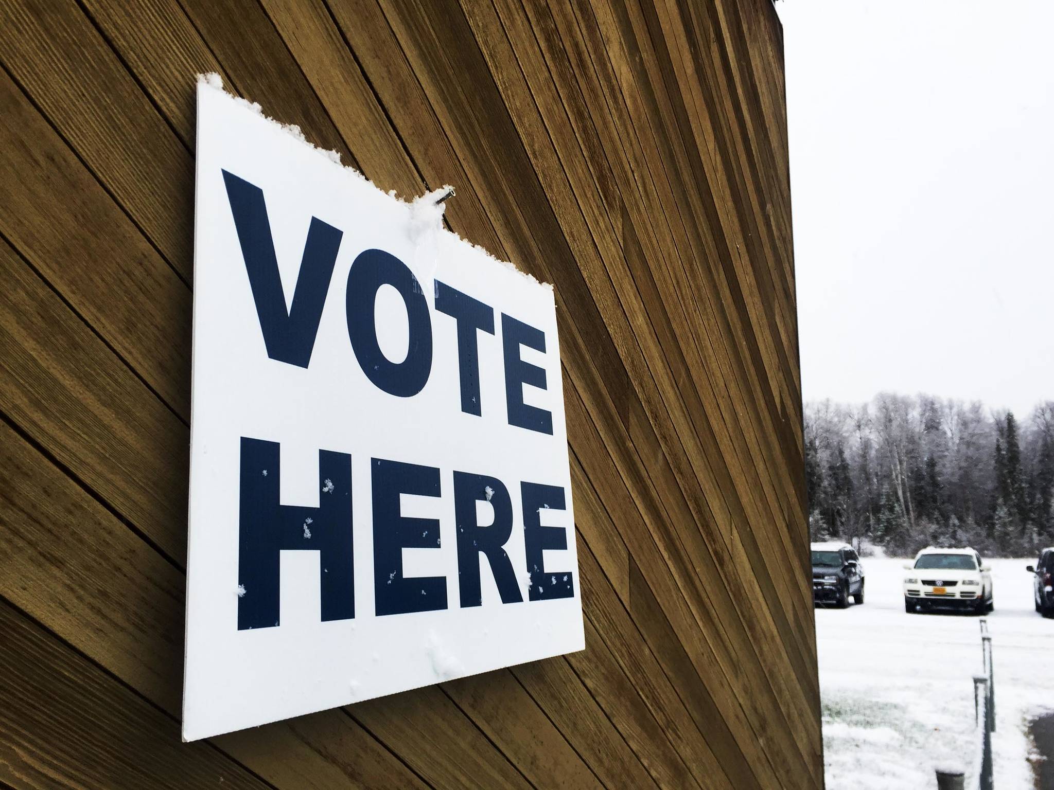 Snow clings to a sign marking a polling place at the Soldotna Regional Sports Complex on Tuesday, Oct. 24, 2017 in Soldotna, Alaska. (Photo by Elizabeth Earl/Peninsula Clarion, file)