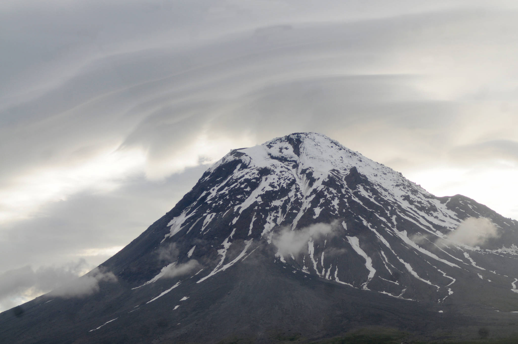 Clouds and smoke curl around the top of Augustine Volcano on Sunday, June 4, 2017 on Augustine Island, Alaska. The remote island in Cook Inlet is composed of little more than the volcano and its surrounding debris. (Elizabeth Earl/Peninsula Clarion, file)